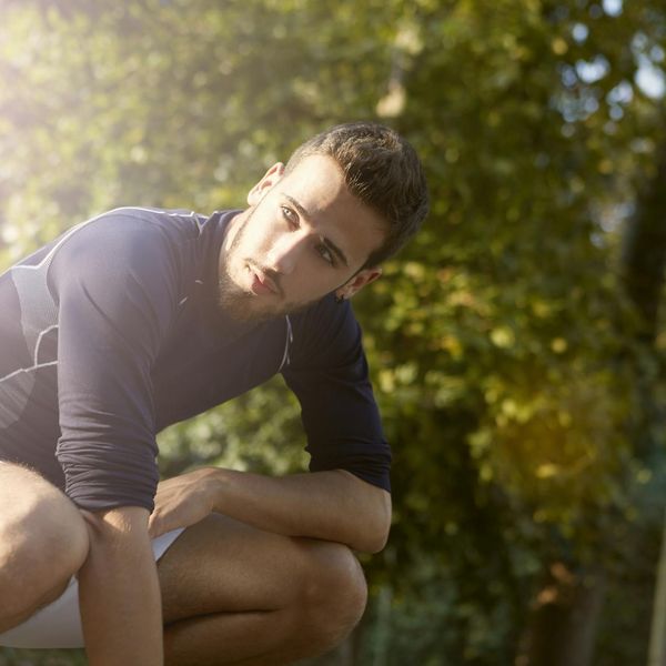 Man in a state of calm focus before a workout, natural light.